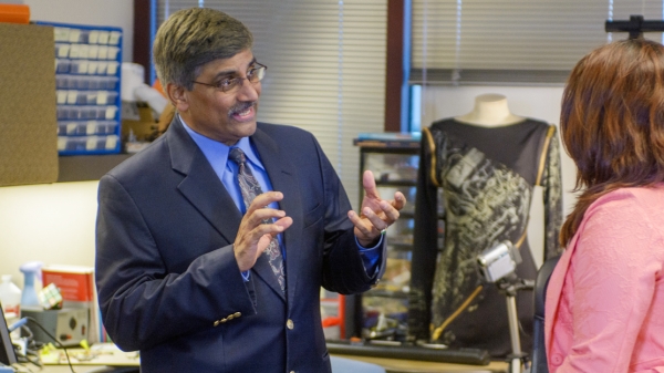 Sethuraman Panchanathan talks with a student in the Center for Cognitive Ubiquitous Computing