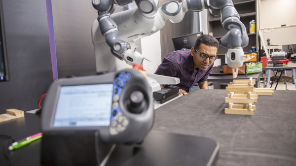 man working with a robot in a lab