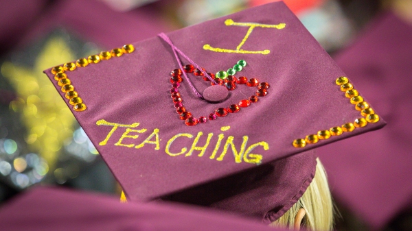 graduation cap with "I &lt;3 teaching" on it.