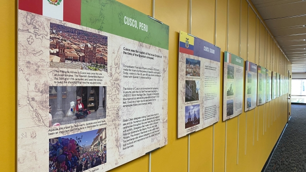 Exhibit panels with text about cities in the Tempe Sister Cities program hanging on a yellow wall.