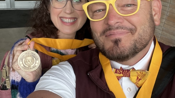 Jodi and Shawn Banzhaf pose for selfie wearing their Master’s Distinction Medallions.