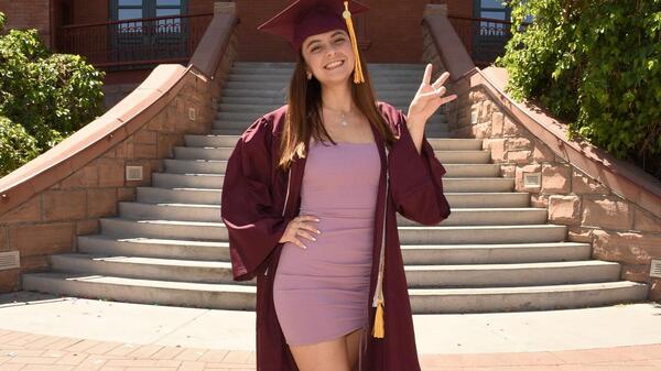 Outstanding Graduate Valeria Reyes standing in front of Old Main at ASU