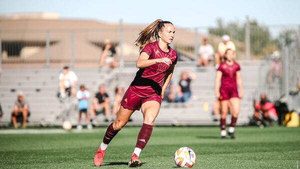 woman playing soccer during a match