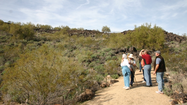photo of Deer Valley Petroglyph Preserve visitors looking at rock art