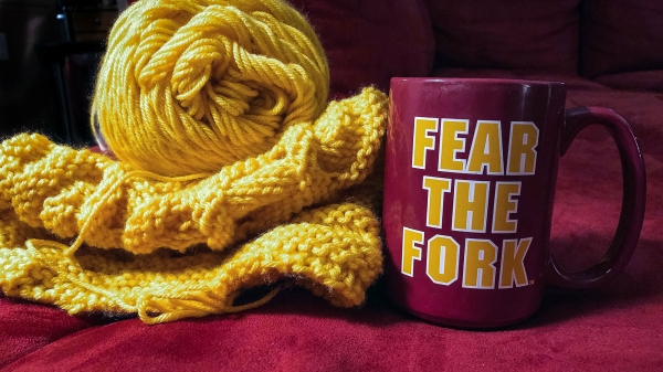 gold yarn and mug that says "Fear the Fork"