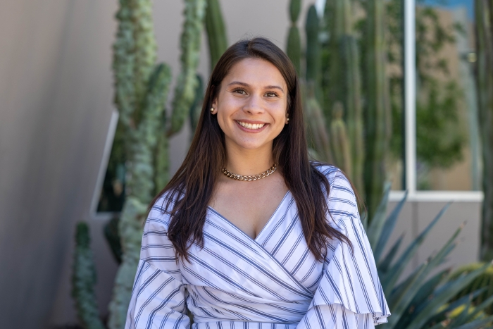 A young woman smiles at the camera