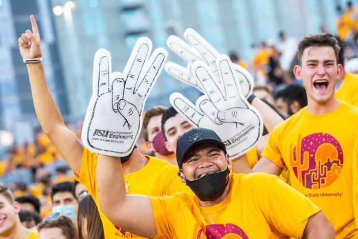 students waving foam fingers