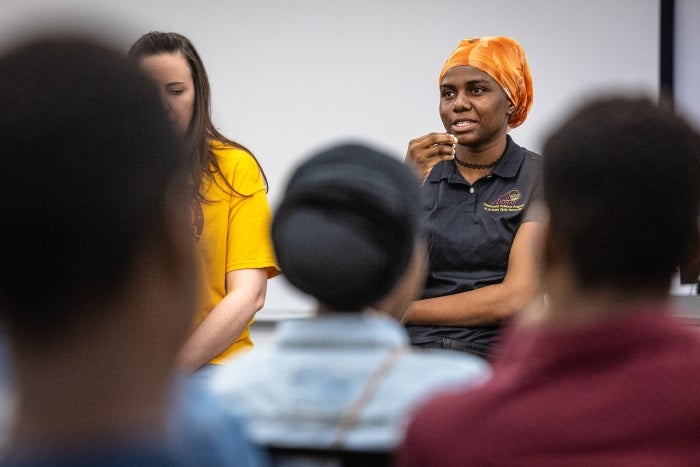 Woman speaking to group in classroom