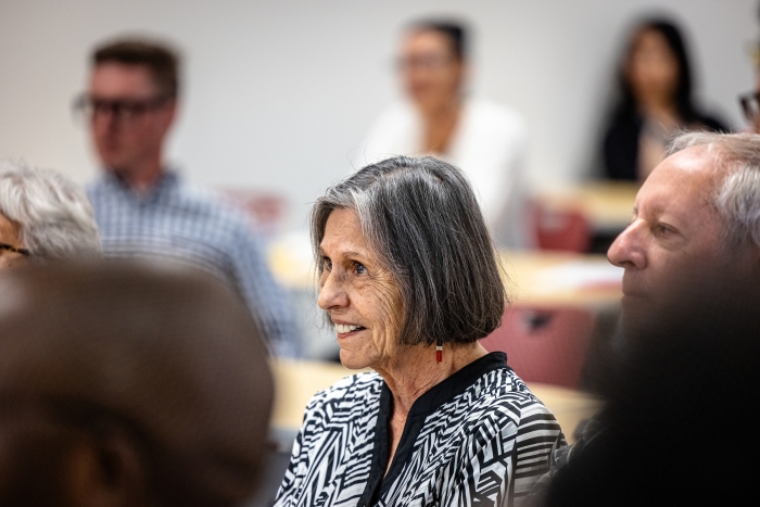 Woman in audience listening to presentation