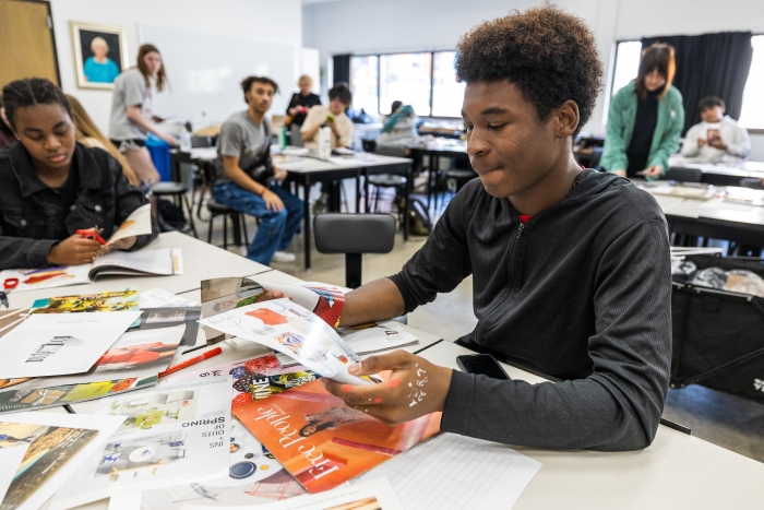 Students flipping through fashion magazines and art