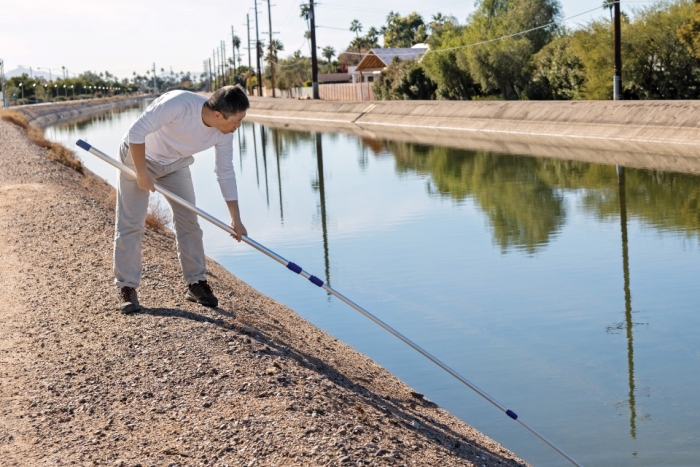 Man collects water samples from Phoenix canal