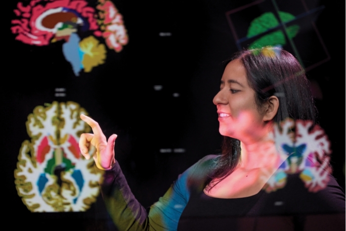 woman interacting with brain scans
