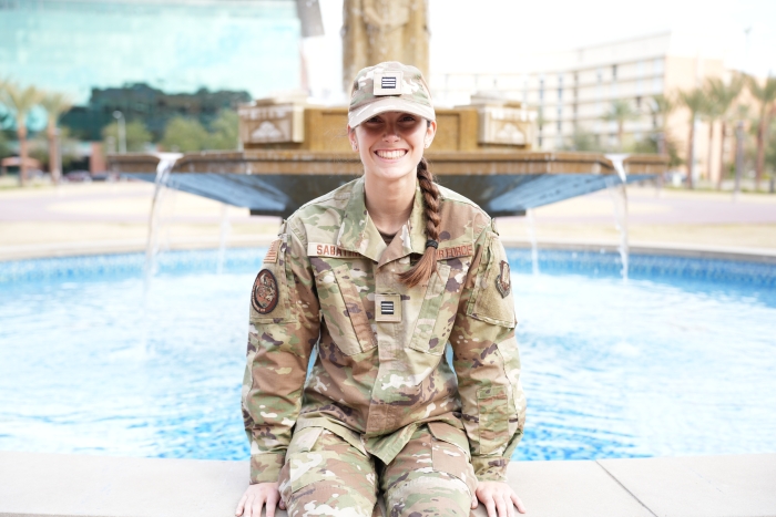 Giavonna Sabatini sits in Air Force ROTC gear on the edge of a fountain.
