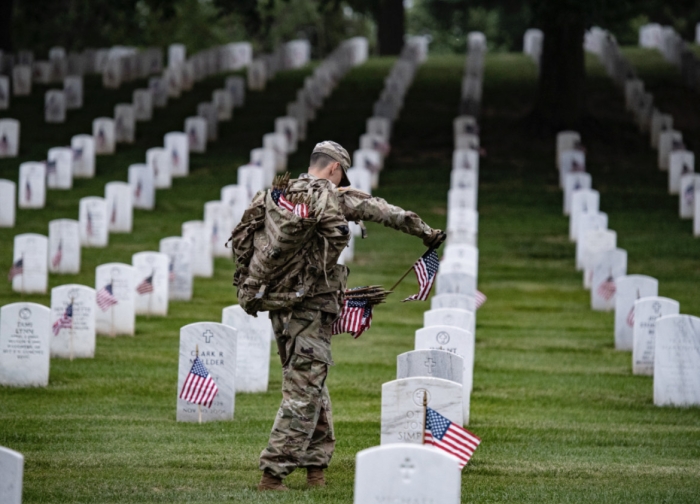 Soldier planting flags