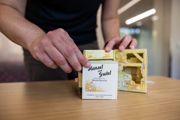 Librarian displays Hansel and Gretel book