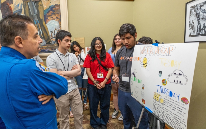 Students presenting a research poster.