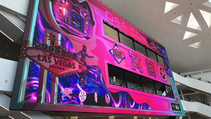 A pink and purple mural at the entrance to DEF CON 2024.