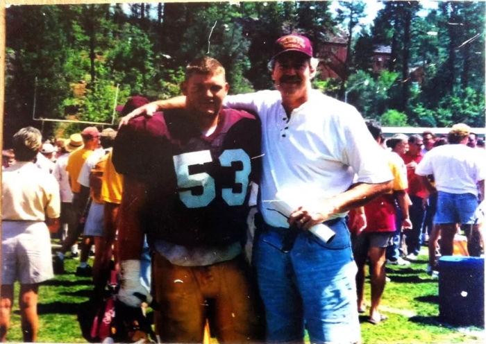 Photo of an ASU football player and his dad at a training camp in Payson