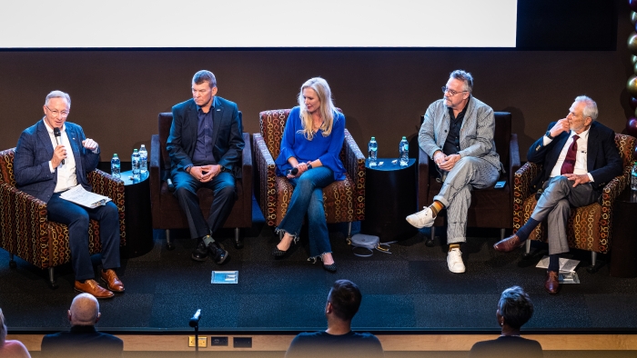 Five people sit on a stage