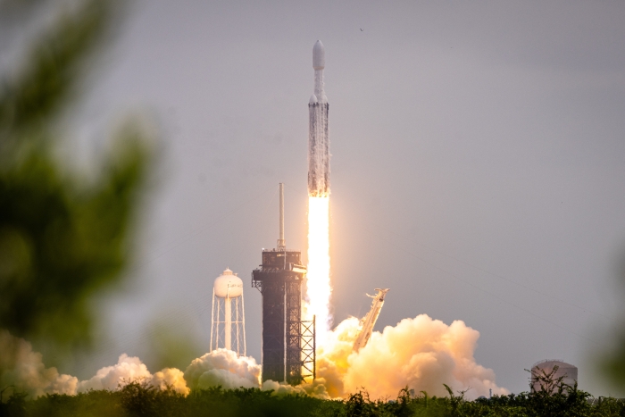 A SpaceX rocket lifts off from a launch pad