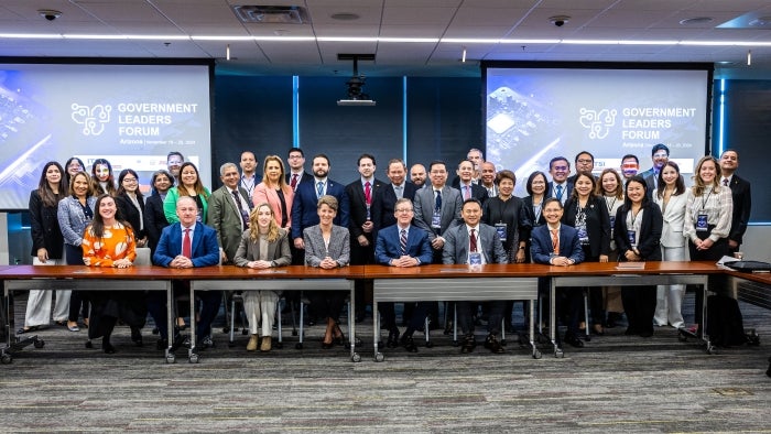 A group photo of about 40 people in a conference room