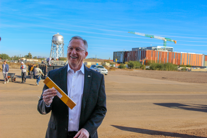 Mayor Giles accepts a piece of the flooring to commemorate the relationship between the city of Mesa and ASU. 