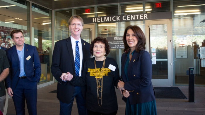 Mary Jo Helmick, center, in front of the doors of the newly renamed Paul C. Helmick Center with Kyle Squires, dean of the Fulton Schools at ASU, left, and Nancy Gonzales, executive vice president and university provost, right. Photographer: Erika Gronek/ASU