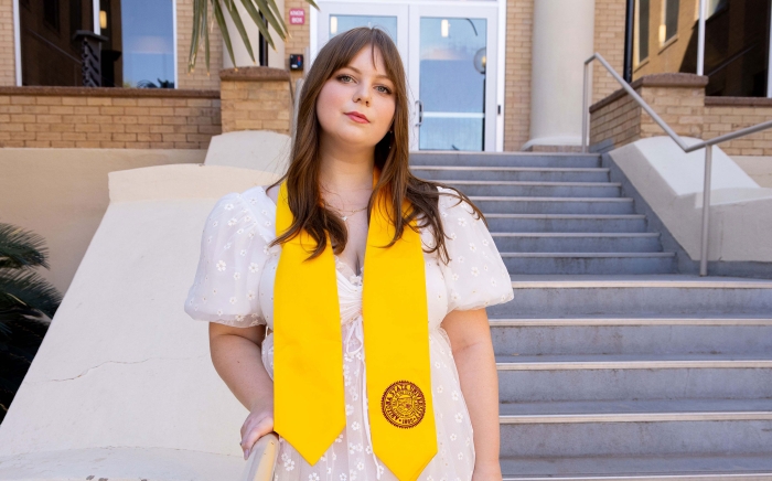  poses in her graduation stole