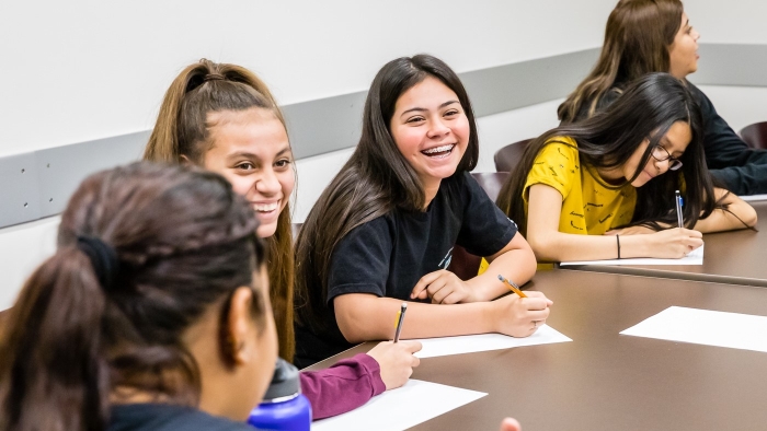 Image of Students writing at ASU’s annual Día De Los Niños, Día De Los Libros celebration 2019, photo by Bruce Matsunaga