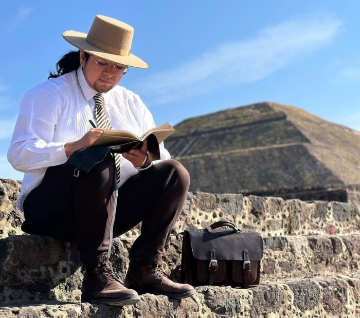  sits on the steps of a Mesoamerican pyramid site