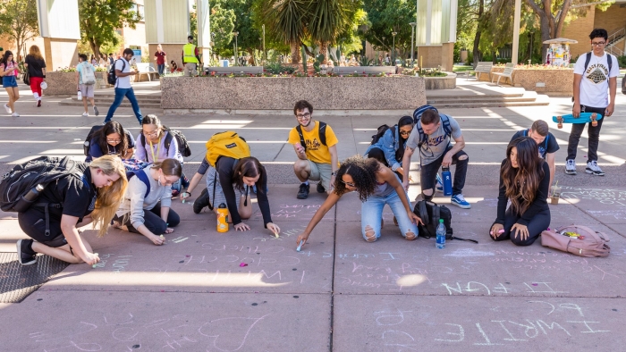 Image of ASU students writing with chalk during National Day on Writing activities 2019, photo by Bruce Matsunaga