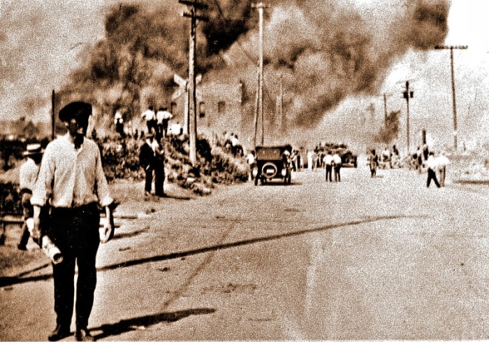 historical photo of a street town with lots of smoke in background