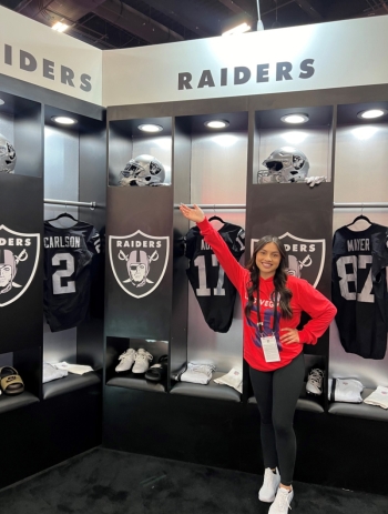 Woman posing in Raiders locker room