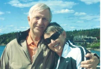 A man and a woman are hugging and smiling