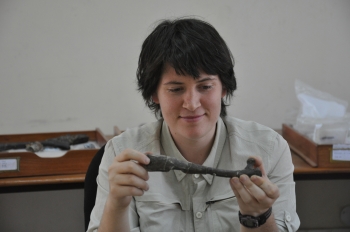 researcher with fossil bone