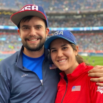 Two people in red, white and blue pose for the camera.