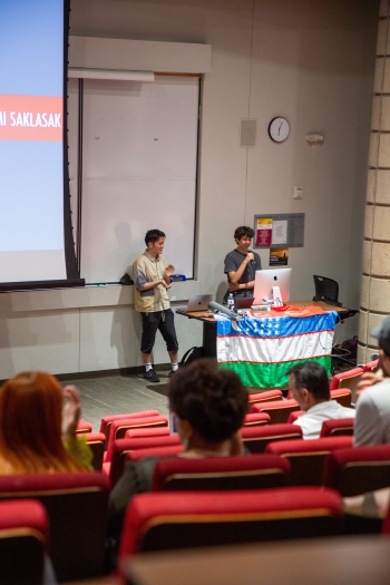 Students presenting at the front of a classroom.