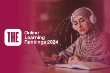 Woman wearing hijab with headphones, working on a laptop and taking notes, with text "THE Online Learning Rankings 2024."