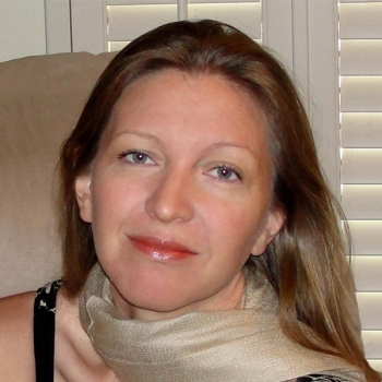 Woman in biege scarf smiling