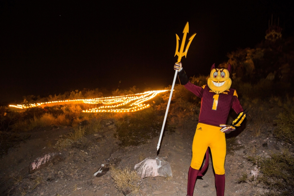 Sparky in front of a lit up A on A Mountain