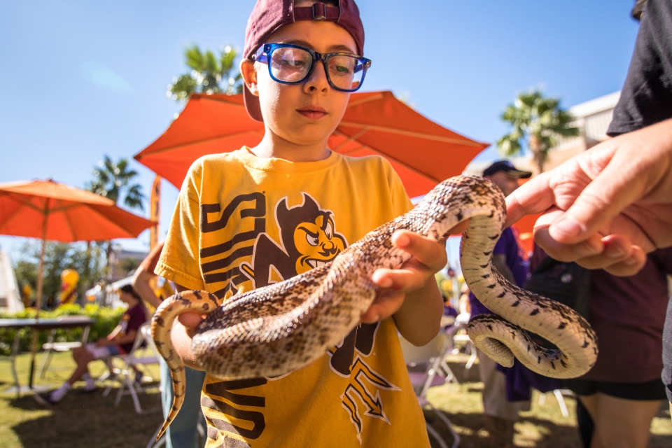 child holding a snake