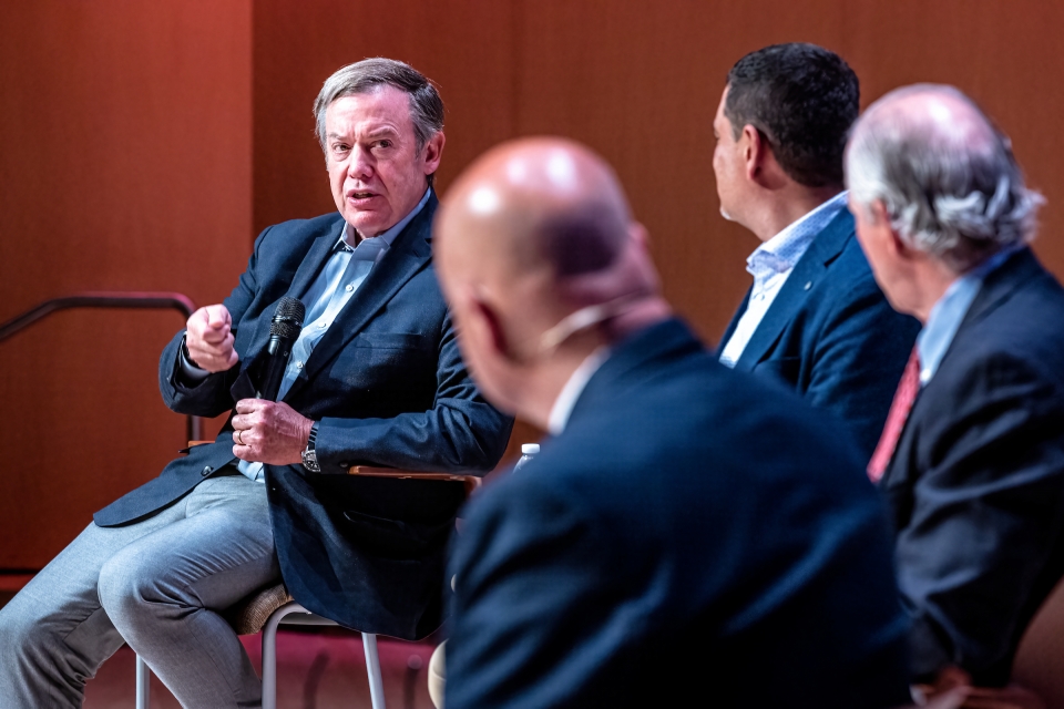 Pres. Michael Crow talking to other university presidents at an event