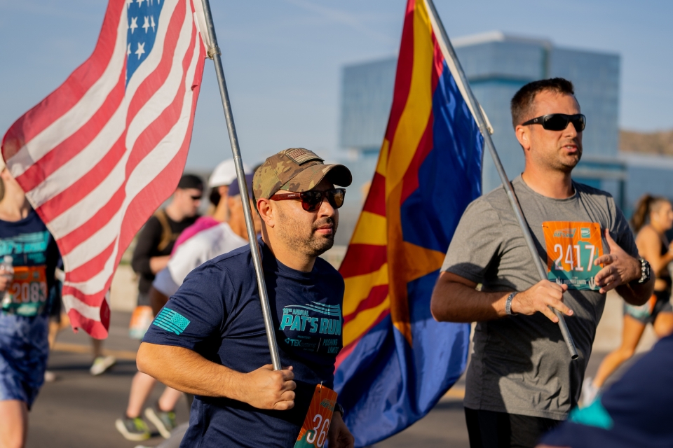 Participants carrying the American and Arizona flags during race