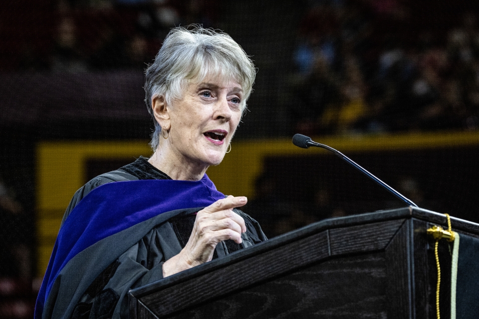 Ruth McGregor speaking at a lectern during ASU Graduate Commencement
