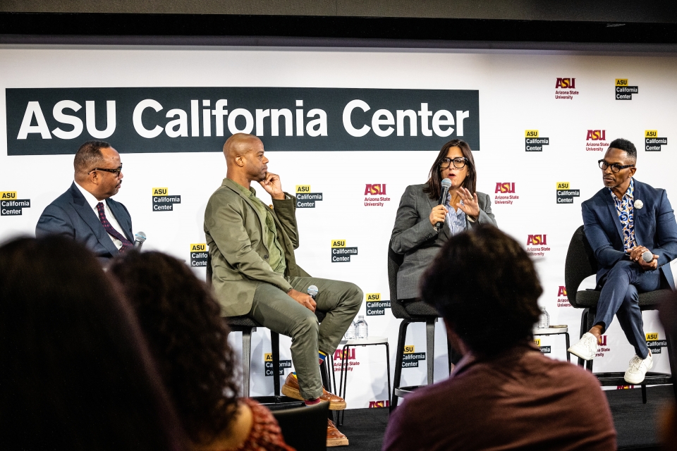 Three men and a woman sit on a stage as part of a panel with a sign behind them that reads ASU California Center
