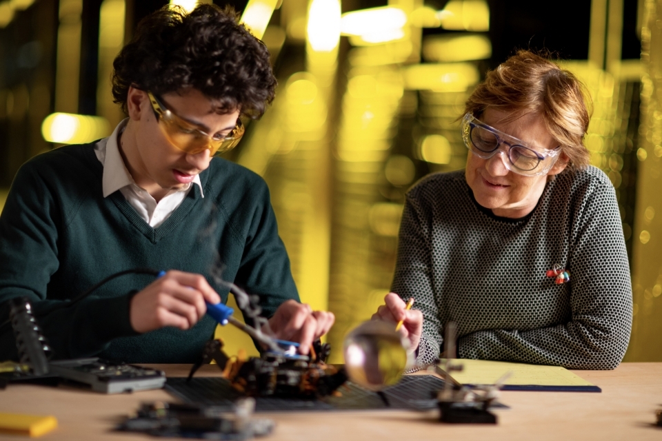 Student and professor work on engineering project together