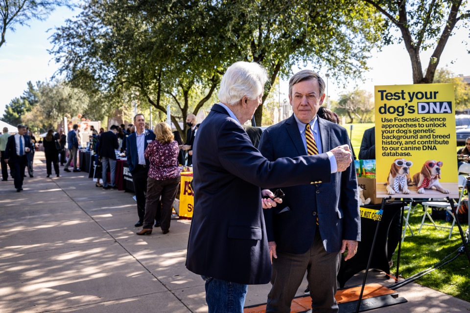ASU President Michael Crow learns more on how students at the New College use dog DNA to help aid in local criminal investigations