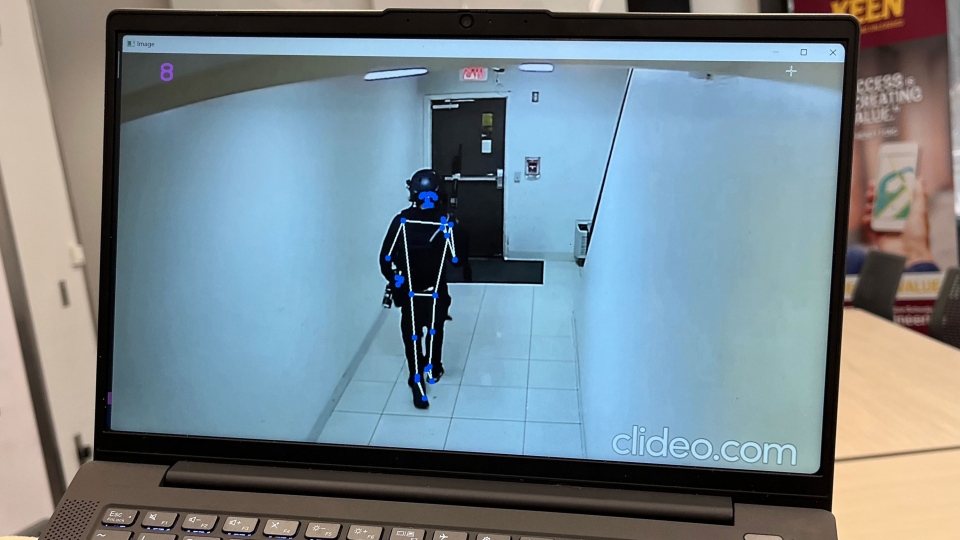 Computer-generated person on computer screen in a hallway