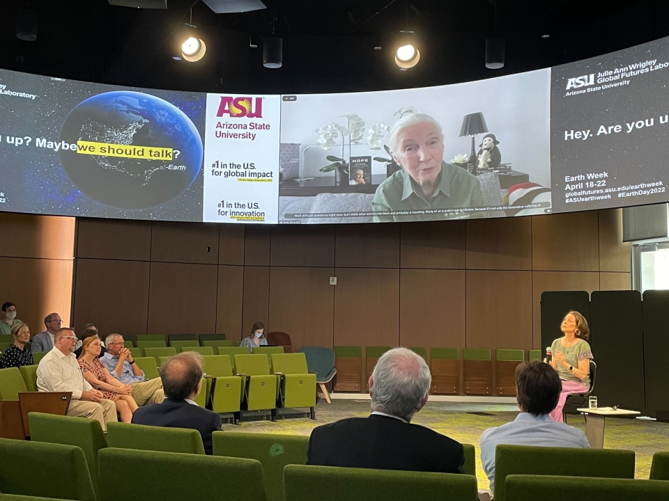 Jane Goodall joining an event remotely on a big screen TV