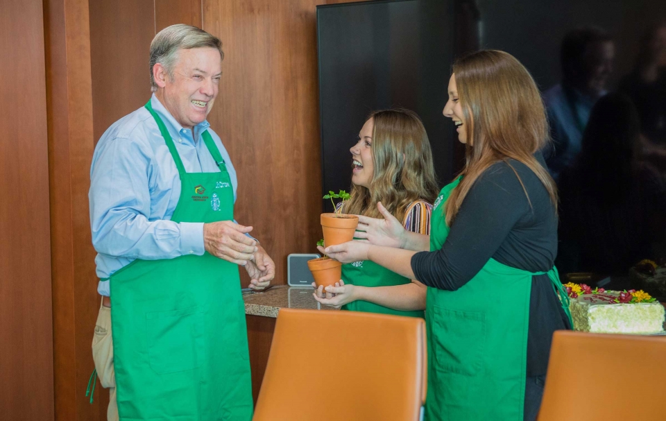 ASU President Michael Crow accepts coffee trees from Starbucks partners